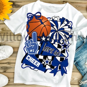 May include: White t-shirt featuring a basketball, pom-pom, and other cheerleading graphics in blue and orange. The shirt includes the text "#1", "CHEER", and "LET'S GO". The design is suitable for sports fans.