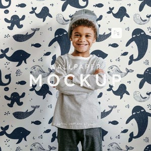 May include: A child wearing a striped long-sleeve shirt and a gray beanie stands in front of a wallpaper with a whale and fish pattern. The wallpaper has the words "WALLPAPER MOCKUP" in white.