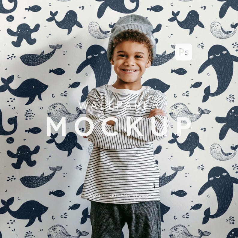 May include: A child wearing a striped long-sleeve shirt and a gray beanie stands in front of a wallpaper with a whale and fish pattern. The wallpaper has the words "WALLPAPER MOCKUP" in white.