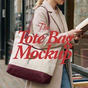 May include: A canvas tote bag with a burgundy bottom and straps, featuring a floral design and a zippered pocket. The text "The Tote Bag Mockup" is printed in red. The bag is carried by a person wearing a beige coat.