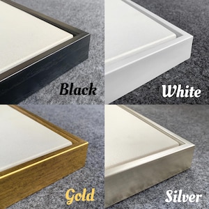 May include: Four framed canvases with different coloured frames: black, white, gold, and silver. Each frame surrounds a white canvas. The colours of the frames are labelled with the words "Black", "White", "Gold", and "Silver".