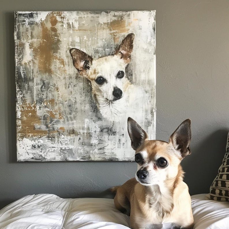 May include: An abstract painting of a Chihuahua dog with a white and brown coat hangs on a gray wall. A real Chihuahua dog with a similar coat color sits on a white bed in front of the painting.