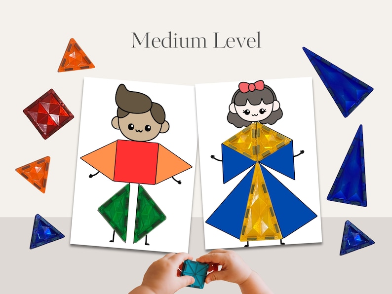 May include: Educational toy set featuring magnetic tiles and illustrated cards. The cards depict cartoon figures constructed from geometric shapes. The text "Medium Level" is displayed above the cards. Various colored magnetic tiles are scattered around the cards.