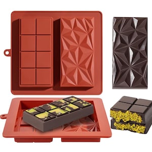 May include: A red silicone chocolate mold with two different bar designs. One mold has eight rectangular sections, and the other has a geometric pattern. Two chocolate bars are shown, one in the mold and one removed, with a geometric design.