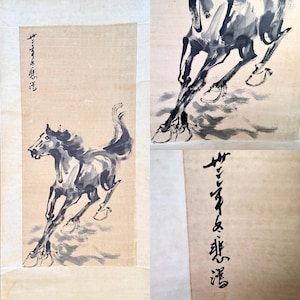 May include: A hanging scroll featuring a black ink wash painting of a galloping horse on light tan paper. The artwork includes vertical black calligraphic text in the upper left corner and a small red seal mark near the bottom right edge.