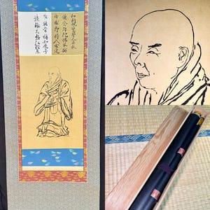 May include: A Japanese hanging scroll featuring a black ink line drawing of a monk on a gold background, with calligraphy at the top and a blue border with petal motifs. The set includes a close-up of the portrait and a wooden storage box.