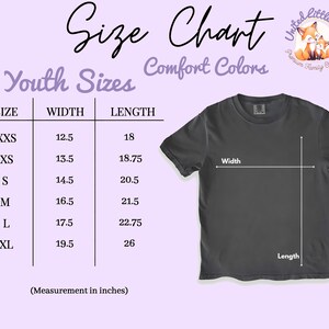 May include: A size chart for youth sizes, featuring a dark gray t-shirt. The chart lists sizes XXS to XL, with width and length measurements in inches. The text "Comfort Colors" is also present.