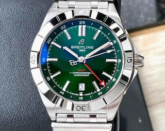 Orologio vintage Breitling Chronomat GMT automatico con quadrante verde e bracciale.