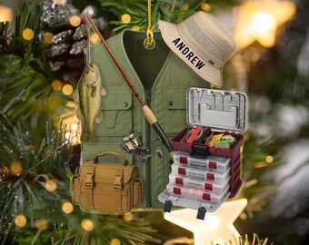 May include: A fishing-themed Christmas ornament featuring a green fishing vest, a fishing rod, a fish, a tackle box, and a hat with the name "Andrew". The ornament is decorated with a star and a pine tree.