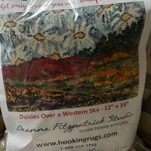 May include: A rug hooking kit featuring a floral design titled "Daisies Over a Western Sky." The kit includes the materials to create a 12" x 14" (30.48 cm x 35.56 cm) hooked rug. The kit is from Deanne Fitzpatrick Studio.