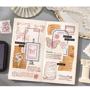 May include: Open journal with butterfly and floral stamps in red ink. Includes a framed butterfly specimen, ticket, and jar illustrations. Decorative elements include torn paper, ink pad, and small decorative pillar.