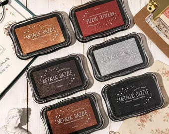 Metallic Pigment Ink Pad, available in gold, silver, black, red, copper, and brown.