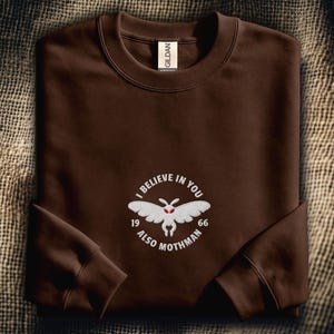 I Believe in You Also Mothman 1966 Embroidered Sweatshirt: Funny Cryptid Urban Legend Design - White Silhouette / Mothman Embroidered Sweatshirt (White Thread)