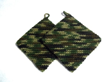 May include: Two crocheted pot holders in a camouflage pattern of green, brown, and black.