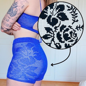 May include: A bright blue crochet two-piece set. The top is a halter style with a cutout, and the shorts feature a floral pattern. The image also includes a close-up of the floral pattern design.