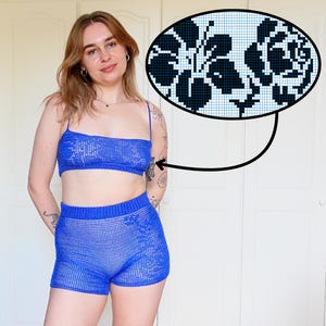 Puede incluir: Un conjunto de dos piezas de ganchillo azul vibrante, que incluye un top corto y pantalones cortos. El top tiene tirantes finos y los pantalones cortos tienen una cintura cómoda. Una incrustación muestra un patrón floral en blanco y negro. El conjunto está hecho de un material similar a la malla.