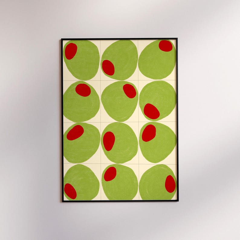 May include: A framed art print featuring a repeating pattern of green olive shapes with red centers. The olives are arranged in a grid against a cream-colored background, with a black frame. The artwork has a modern, minimalist style.