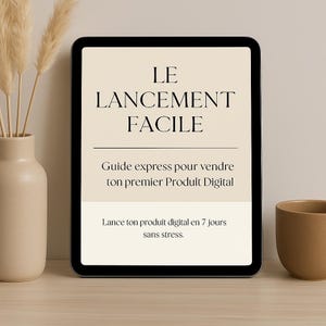 May include: A digital tablet displaying a guide titled "LE LANCEMENT FACILE" with the text "Guide express pour vendre ton premier Produit Digital" and "Lance ton produit digital en 7 jours sans stress."