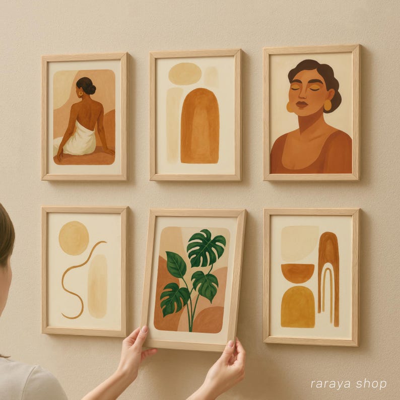 May include: Set of six minimalist art prints in wooden frames. The prints feature abstract shapes, a woman with closed eyes, and a green tropical plant. The prints are in shades of brown, beige, and green.