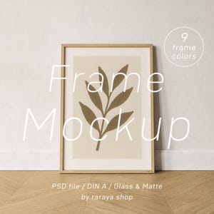 May include: A framed art print mockup featuring a botanical illustration of a plant with brown leaves on a beige background. The frame is light brown. Text on the image says "Frame Mockup" and "9 frame colors".
