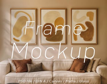 May include: Three framed abstract art pieces with neutral colors hang above a cream-colored sofa. The artwork features organic shapes in shades of brown and beige. The text "Frame Mockup" is overlaid on the image. The scene is a modern interior design.