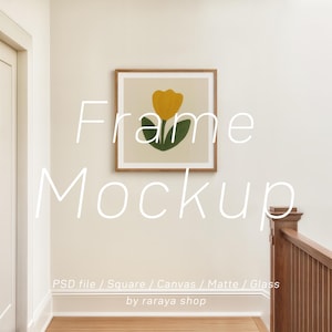 May include: A framed art print featuring a yellow tulip with green leaves on a cream background. The artwork is displayed in a wooden frame on a white wall. Text on the image reads "Frame Mockup" and "PSD file / Square / Canvas / Matte / Glass by raraya shop."