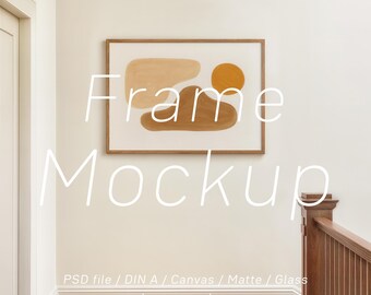 May include: A framed artwork with abstract shapes in shades of beige and brown hangs on a white wall. The artwork is in a wooden frame. The text "Frame Mockup" is overlaid on the image. The text "PSD file / DIN A / Canvas / Matte / Glass by raraya shop" is below the frame.