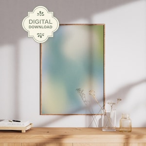May include: A framed art print with a soft, blurred abstract design in shades of blue, green, and yellow. The print is labeled "DIGITAL DOWNLOAD" and is displayed on a wooden surface with decorative elements.