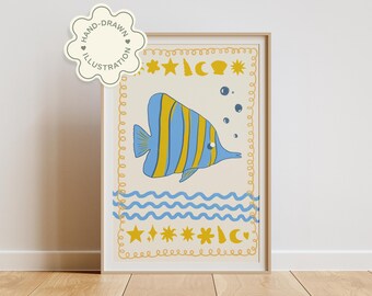 May include: A framed art print featuring a whimsical illustration of a blue and yellow striped fish. The artwork includes decorative elements like stars, moons, and wavy lines, all in a soft color palette. The print is labeled "HAND-DRAWN ILLUSTRATION".