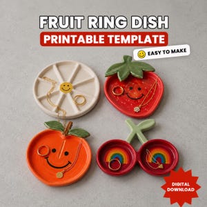 May include: A collection of colorful ceramic fruit-shaped ring dishes. The dishes include a white daisy, a red strawberry, an orange peach, and a pair of cherry dishes, each with a smiling face design. The text "FRUIT RING DISH PRINTABLE TEMPLATE" is at the top.