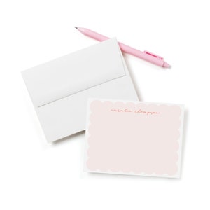 May include: A pink and white stationery set with a scalloped edge and the name "natalie thompson" written in pink script.