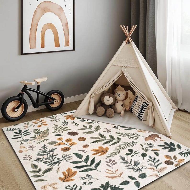 May include: A white play tent with a brown wooden frame, set up in a room with a beige rug featuring a leafy pattern. The rug has a brown, green, and yellow colour scheme. A child's bicycle and a framed watercolour painting of a rainbow are also visible in the room.