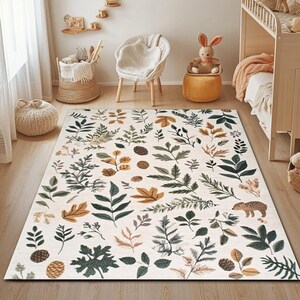 May include: A white area rug with a repeating pattern of green leaves and brown branches. The rug has a light brown background and features a small brown hedgehog in the bottom right corner.