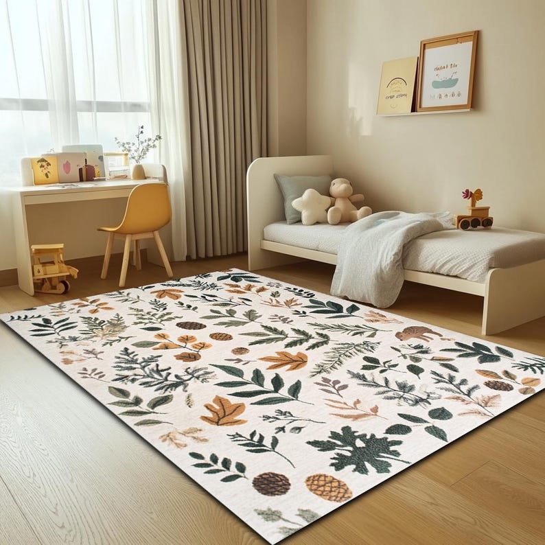 May include: A white rug with a pattern of green and brown leaves and pine cones. The rug is in a room with a white bed and a wooden desk.