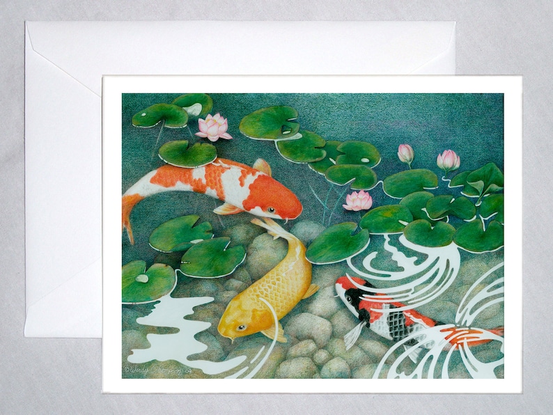 May include: Three koi fish swim in a pond with lily pads and pink flowers. The fish are orange, yellow, and black and white.