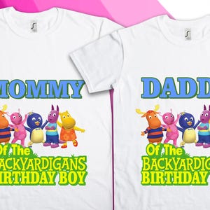 May include: Two white t-shirts with a design featuring characters from the show "Backyardigans". One shirt says "Mommy of the Backyardigans Birthday Boy" and the other says "Daddy of the Backyardigans Birthday Boy".