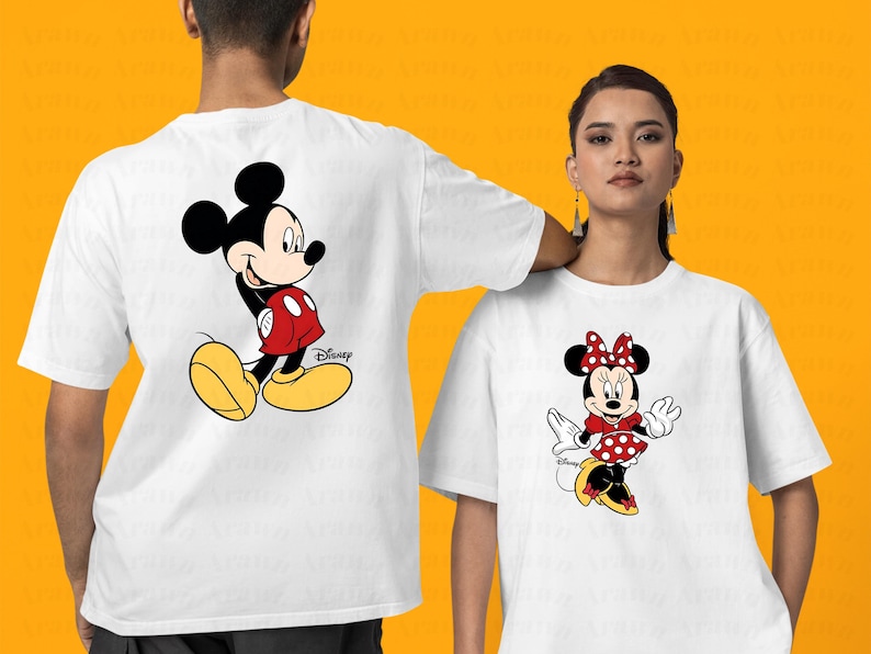 K&ouml;nnte beinhalten: Zwei wei&szlig;e T-Shirts mit einem Cartoon-Bild von Mickey Mouse und Minnie Mouse. Das Mickey Mouse Shirt zeigt Mickey Mouse in einem roten und gelben Outfit. Das Minnie Mouse Shirt zeigt Minnie Mouse in einem roten und wei&szlig;en Polka-Dot-Kleid mit einer roten Schleife.