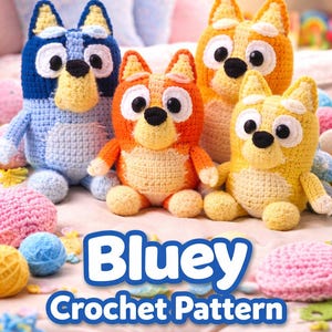 May include: Four crocheted dog figures in blue, orange, and yellow, with black and white eyes, sit on a pink surface. The text "Bluey Crochet Pattern" is displayed in a blue banner below the figures. Yarn balls are scattered around.