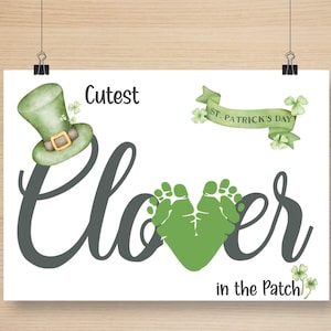 May include: A St. Patrick's Day print featuring a green leprechaun hat, shamrocks, and the text "Cutest Clover in the Patch." The word "Clover" is formed by green footprints. A green banner reads "St. Patrick's Day."