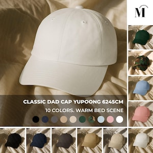 May include: A white dad cap with a curved brim. The text on the image reads "CLASSIC DAD CAP YUPOONG 6245CM 10 COLORS. WARM BED SCENE." Additional caps in various colors are displayed.