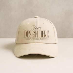 Puede incluir: Gorra de béisbol beige con visera desgastada. La gorra presenta el texto "Your Design Here" en fuente marrón, con "Myrova Studio Mockups" debajo. Es una maqueta para la personalización de diseños.