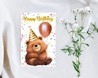 May include: A birthday card with a brown bear wearing a party hat and holding a brown balloon. The card has a white background with colorful confetti and stars. The text "Happy Birthday" is written in gold letters.