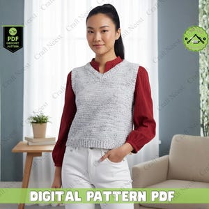 May include: A woman wearing a gray and white crochet vest over a red long-sleeved shirt and white pants. The image includes text that reads "DIGITAL PATTERN PDF" and a logo that says "PDF CROCHET PATTERN".