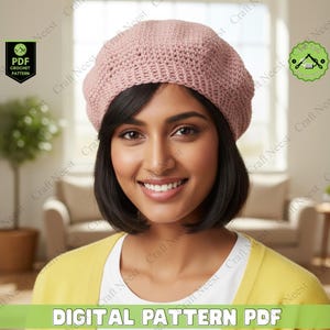 May include: A woman wearing a light pink crocheted beret. The beret is made of a textured yarn and has a classic shape. The image also includes the text "DIGITAL PATTERN PDF".