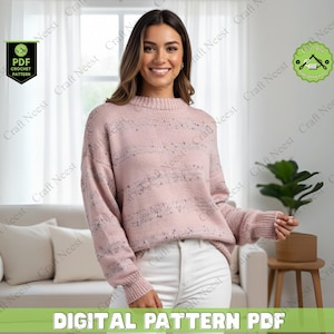 May include: A woman wearing a light pink sweater with a speckled design and white pants. The image includes text that reads "DIGITAL PATTERN PDF" and "PDF CROCHET PATTERN". The background includes a couch, a plant, and a wooden side table.