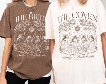 May include: A brown t-shirt and a cream t-shirt, each featuring a graphic print of four figures in dresses and witch hats dancing under a disco ball and tree branches. The text reads THE BRIDE or THE COVEN, Emily's Bachelorette, and NASHVILLE, TN.
