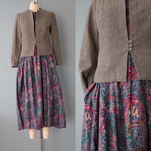 May include: A brown tweed jacket with a paisley print dress. The jacket has a collar and a button closure. The dress has a fitted bodice and a full skirt.