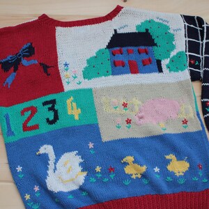 May include: A colorful knitted sweater with a patchwork design. The sweater features a house, a pig, ducks, a swan, and the numbers 1, 2, 3, and 4. The sweater is made of a soft, warm yarn and is perfect for keeping you cozy in the winter.