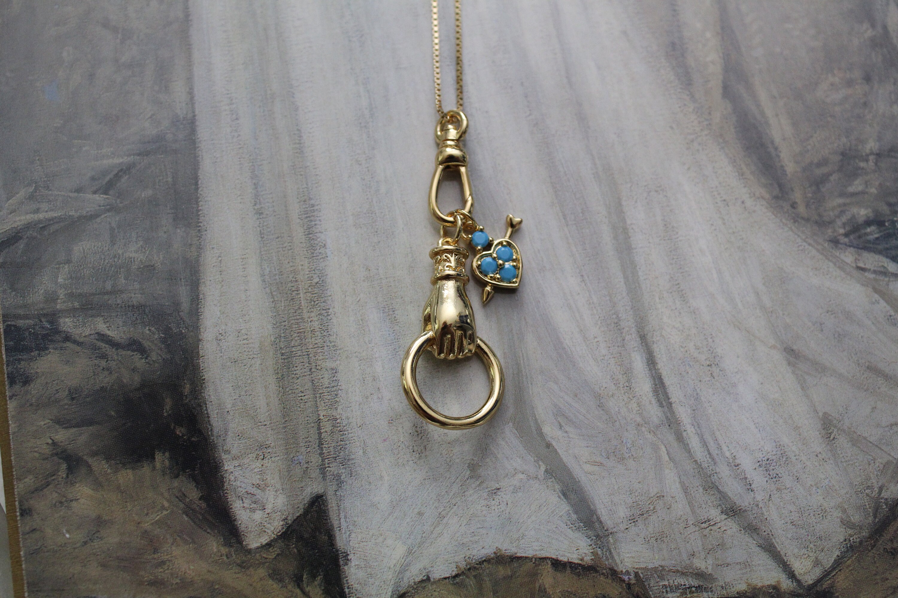 Gold necklace store charm holder