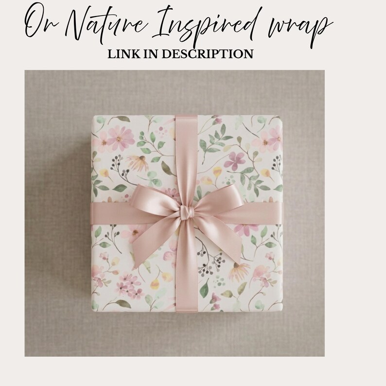 May include: A wrapped gift with floral patterned paper and a blush pink ribbon tied in a bow. The paper features a watercolor design of pink, yellow, and green flowers and leaves on a cream background. Text at the top reads "Or Nature Inspired wrap" and "LINK IN DESCRIPTION".
